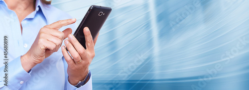 Photo: Hands of woman with a smartphone. Hands of woman with a smartphone.