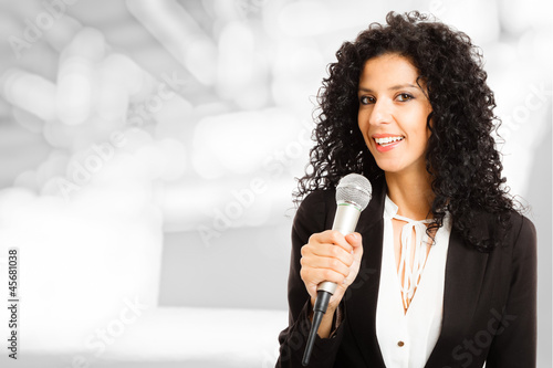 Photo: Woman speaking in a microphone Woman speaking in a microphone