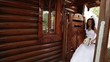 Groom and bride pass in a wooden gate