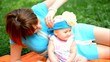 Mother and her cute baby girl play outdoor