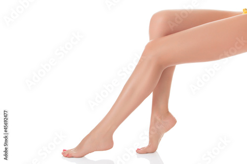 Photo: Long female legs after depilation, isolated on white background Long female legs after depilation, isolated on white background