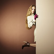 Photo: Photo young beautiful woman in a raincoat in interior Photo young beautiful woman in a raincoat in interior