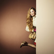 Photo young beautiful woman in a raincoat in interior