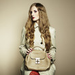 Portrait of a beautiful young woman with a handbag