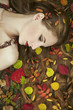 Fashion portrait of a beautiful young woman in autumn garden