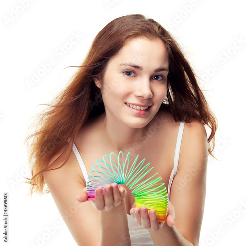Photo: Girl playing with slinky, can be concept of game or balance Girl playing with slinky, can be concept of game or balance