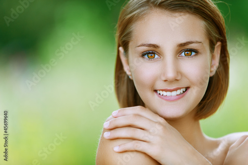 Photo: smiling beautiful young woman close up smiling beautiful young woman close up