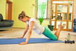 Foto: Happy young woman doing fitness at home. Happy young woman doing fitness at home.