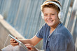 Close up portrait of teen boy with tablet.