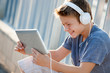 Photo: Cute teen boy with headphones and tablet. Cute teen boy with headphones and tablet.