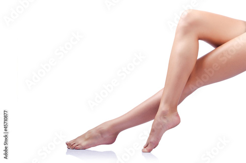 Photo: Long woman legs isolated on white Long woman legs isolated on white