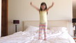 Girl Jumping On Bed