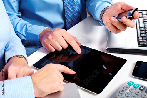 Photo: Business people group working with laptop. Business people group working with laptop.
