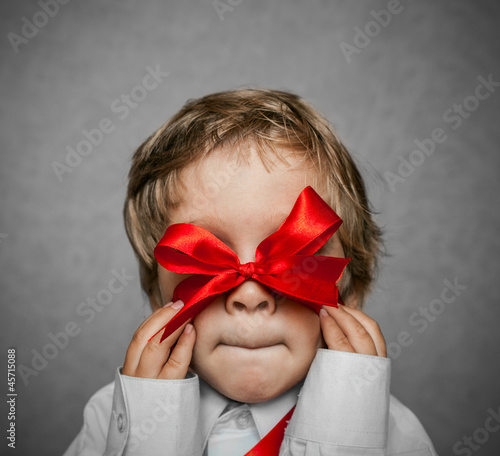 Photo: Small baby with silver gift box Small baby with silver gift box