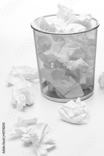 Photo: Office trash bin full of paper waste Office trash bin full of paper waste
