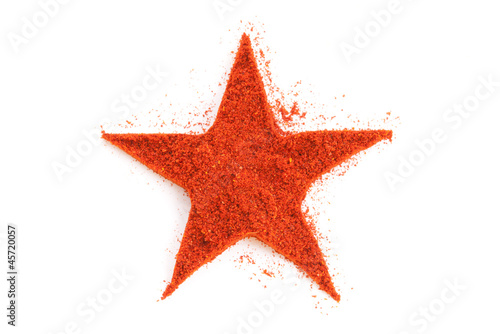 Photo: Pile of ground Paprika isolated in star shape on white backgroun Pile of ground Paprika isolated in star shape on white backgroun
