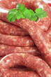 a natural raw sausage on white