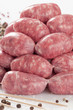 a natural raw sausage on white:toscanelli
