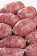 a natural raw sausage on white:toscanelli