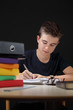 Photo: Young male doing his homework Young male doing his homework