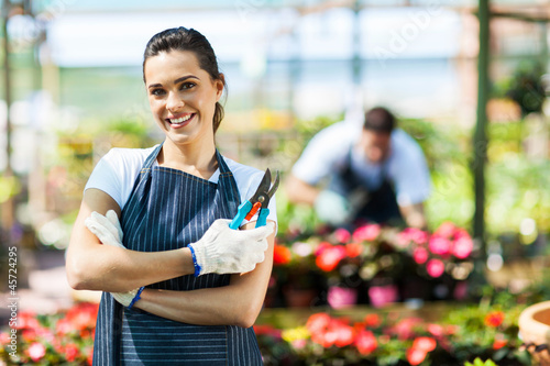 Photo: pretty female nursery worker portrait with pruner pretty female nursery worker portrait with pruner