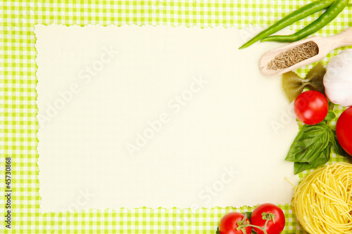 Photo: paper for recipes,vegetables and spices on green background paper for recipes,vegetables and spices on green background
