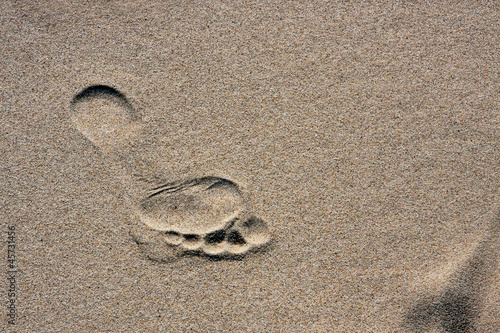 Photo: barefoot footprint on a sand barefoot footprint on a sand