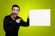 man holding blank white board on yellow backgroud