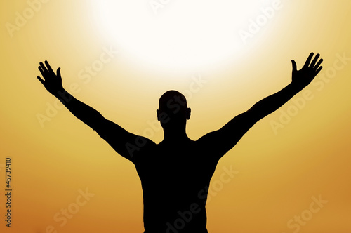 Photo: Man saluting the sun with passion for life Man saluting the sun with passion for life