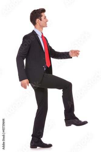 Photo: business man stepping up and moving forward business man stepping up and moving forward