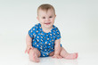gorgeous little baby sat up smiling
