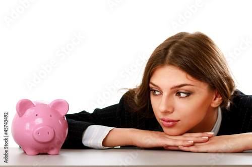 Photo: Young beautiful woman sitting with piggy bank (money box) Young beautiful woman sitting with piggy bank (money box)