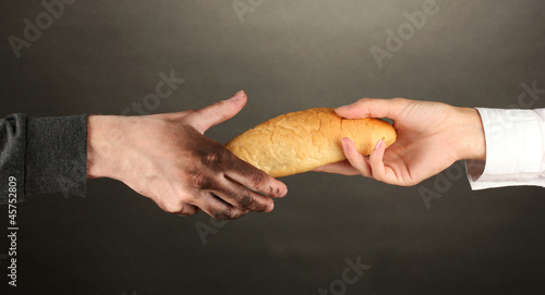 Photo: helping the homeless, on black background close-up helping the homeless, on black background close-up