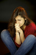 Young woman crying in the dark