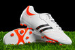 Soccer shoes on the green grass.