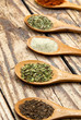 various spices in wooden spoons
