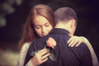 Photo: Love and affection between a young couple at the park Love and affection between a young couple at the park