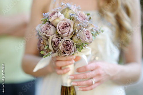 Photo: Bride holding a wedding bouquet Bride holding a wedding bouquet