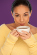 Photo: Woman cooling down her coffee Woman cooling down her coffee