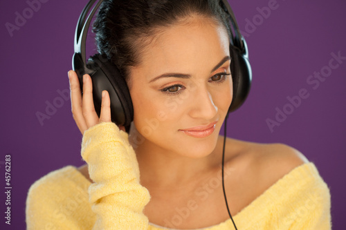 Photo: Beautiful woman listening to music Beautiful woman listening to music