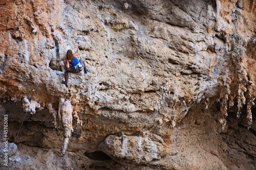 Photo: Female rock climber on a cliff face Female rock climber on a cliff face