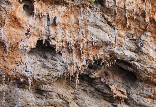 Photo: Female rock climber on a cliff face Female rock climber on a cliff face