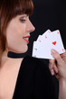 Woman poker player with four aces in hand