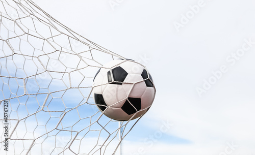 Photo: football in the goal net football in the goal net