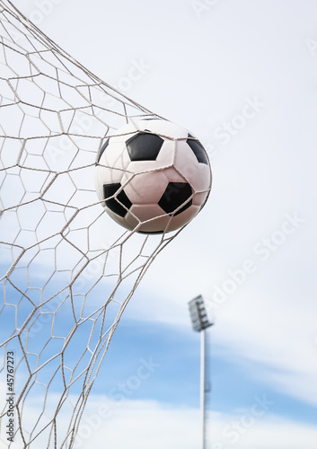 Photo: football in the goal net football in the goal net