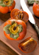 Photo: persimmon on a wooden table persimmon on a wooden table