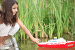 Girl playing with a toy boat on a lake