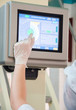 worker pointing the finger to the machine control display