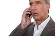 mature man at phone having trouble