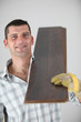 craftsman carrying wooden boards